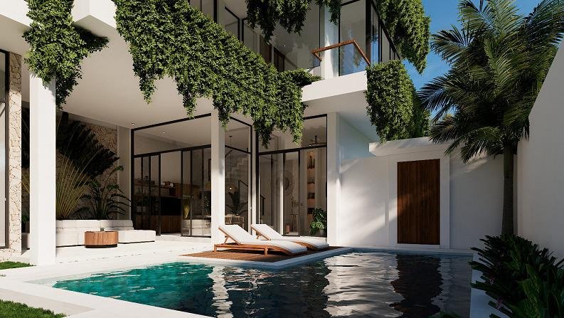 View of a modern Bali villa's pool area with two sun loungers on a wooden deck, sparkling blue water, and lush hanging greenery adorning the villa's facade. Large glass doors offer a glimpse into the stylish interior.